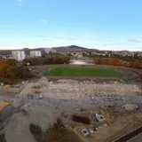 Panoramic view of Corvinul Hunedoara stadium during demolition with construction debris and surrounding city landscape